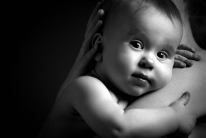 cute baby at hands of the mother in an embrace, monochrome